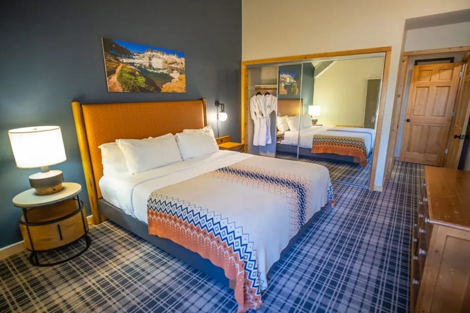 Unwind in a plush king bed with warm, modern style.