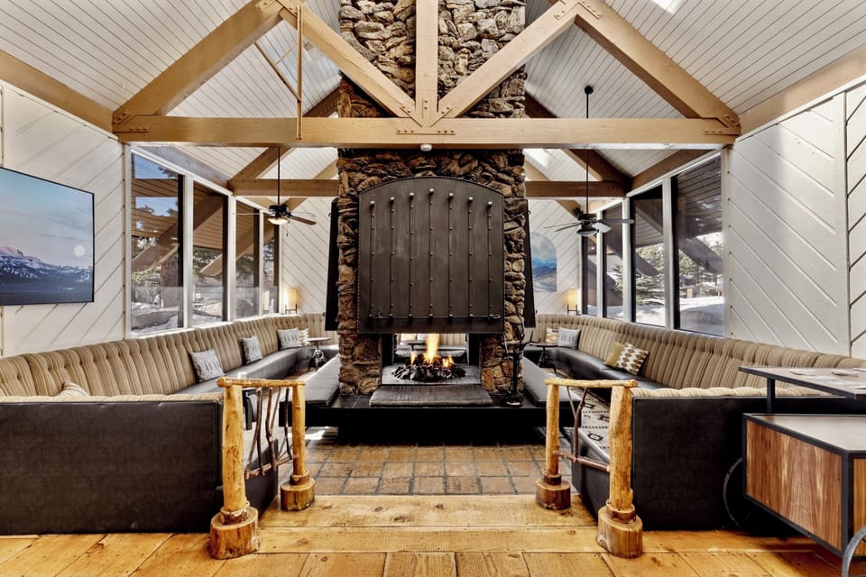 Unwind fireside in a grand lodge lounge with mountain views.