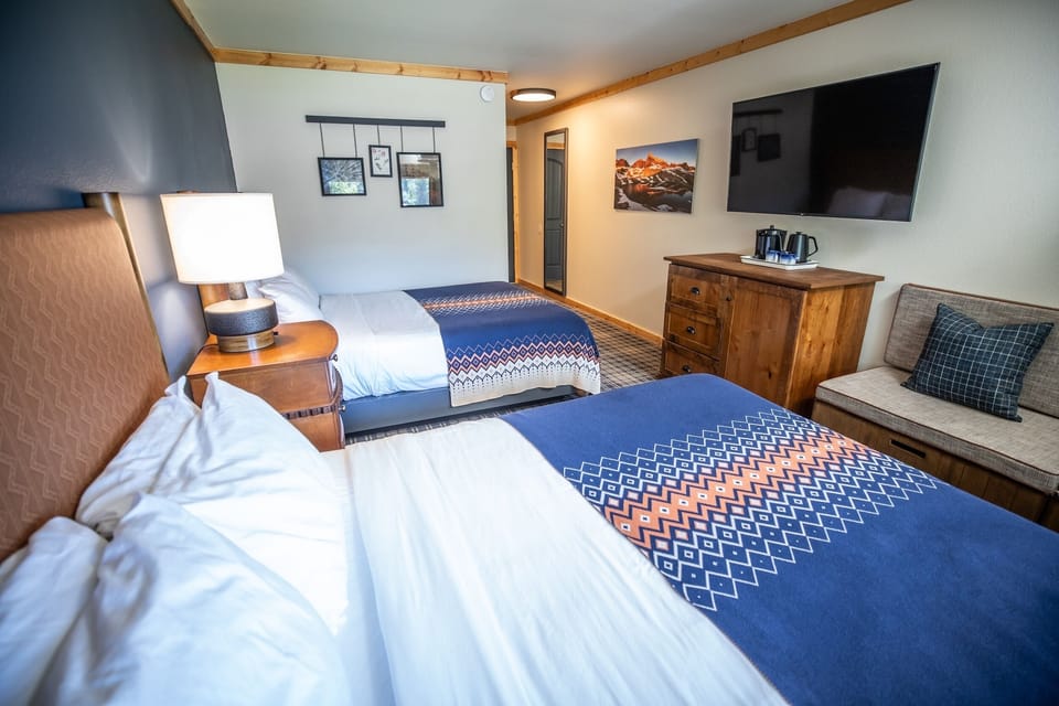Spread out comfortably with seating, TV, and two inviting beds.