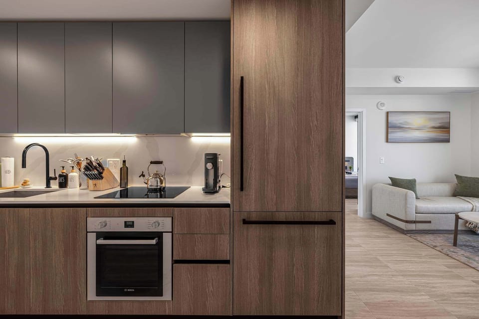 Experience modern living with this sleek kitchen, complete with top-notch appliances and a cozy adjoining living space.