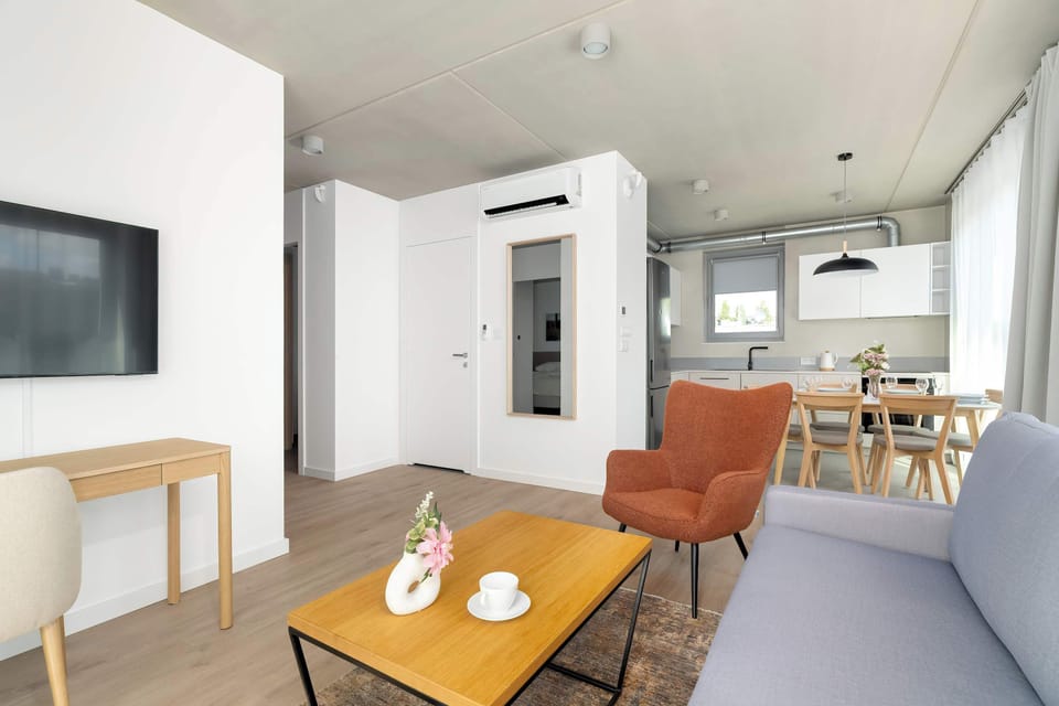 The open space with a lounge and dining area creates a harmonious setting perfect for spending time with loved ones.