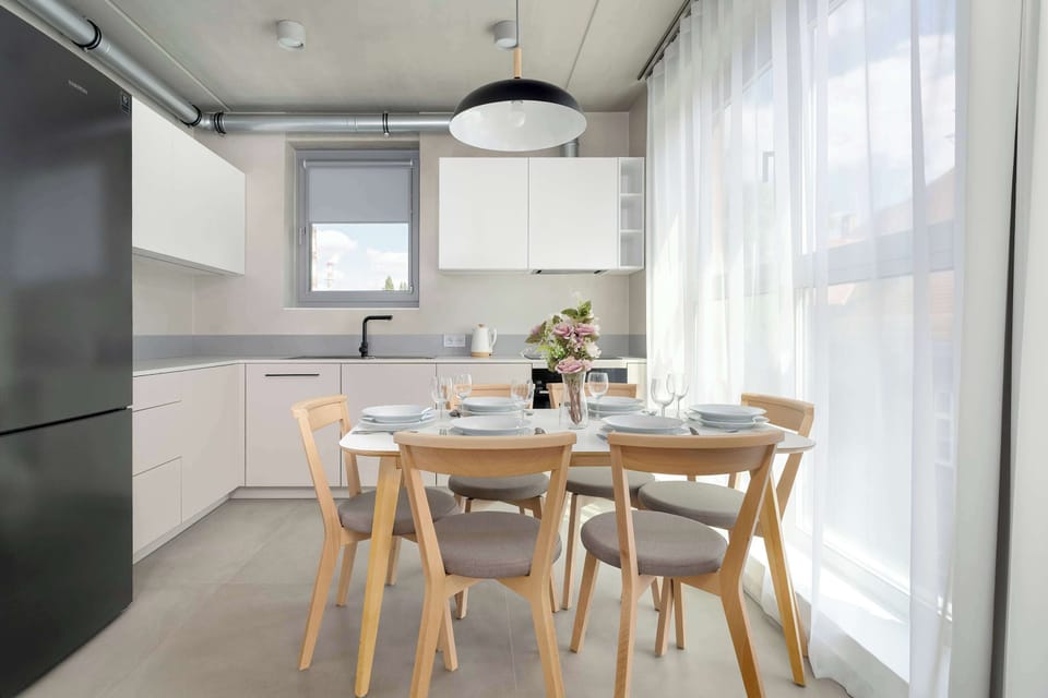 The dining area connected to the kitchen lets you enjoy meals bathed in natural light streaming through large windows.