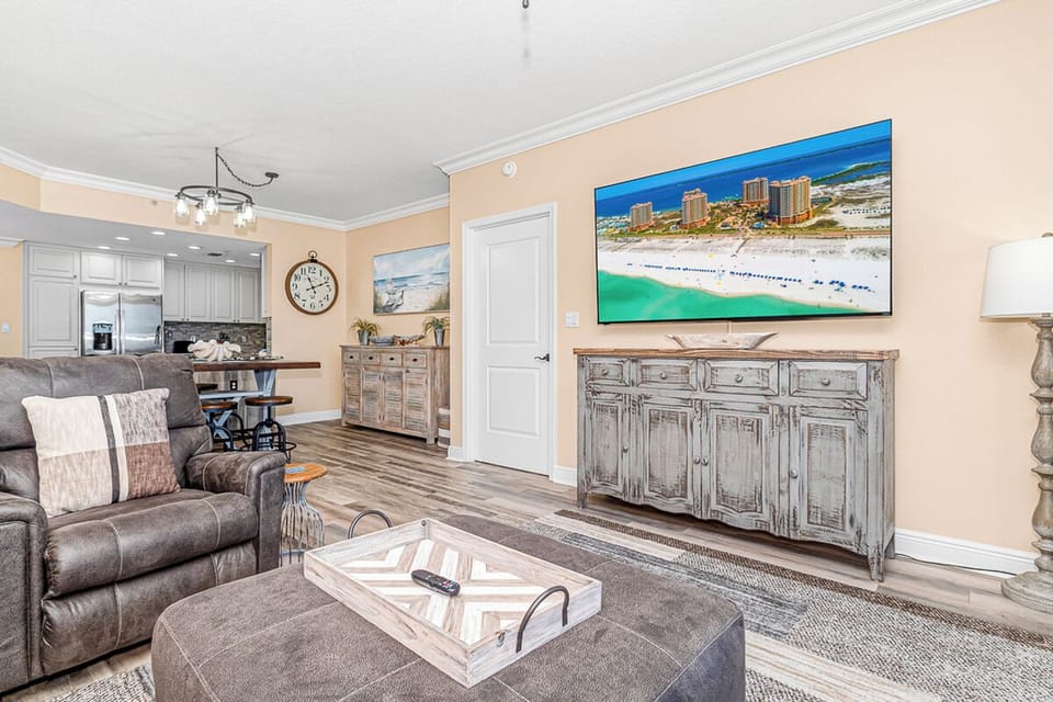 Unwind in your spacious living room with plush seating and coastal artwork that brings beachside tranquility indoors.