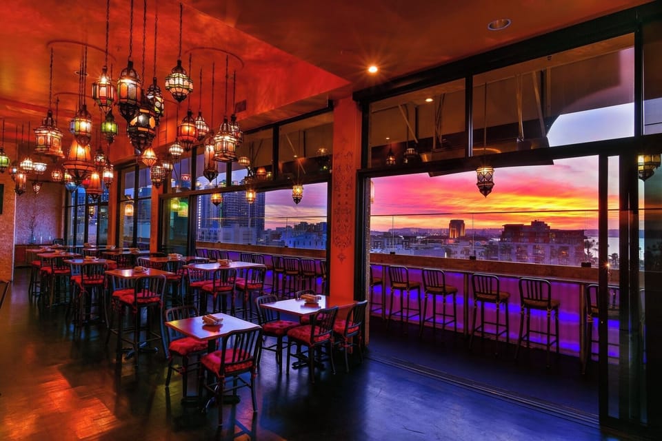 Dine at sunset beneath glowing lanterns and panoramic views.