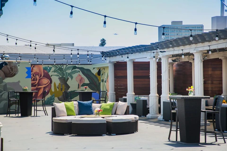 Stretch out on cushioned seating beneath glowing café lights.