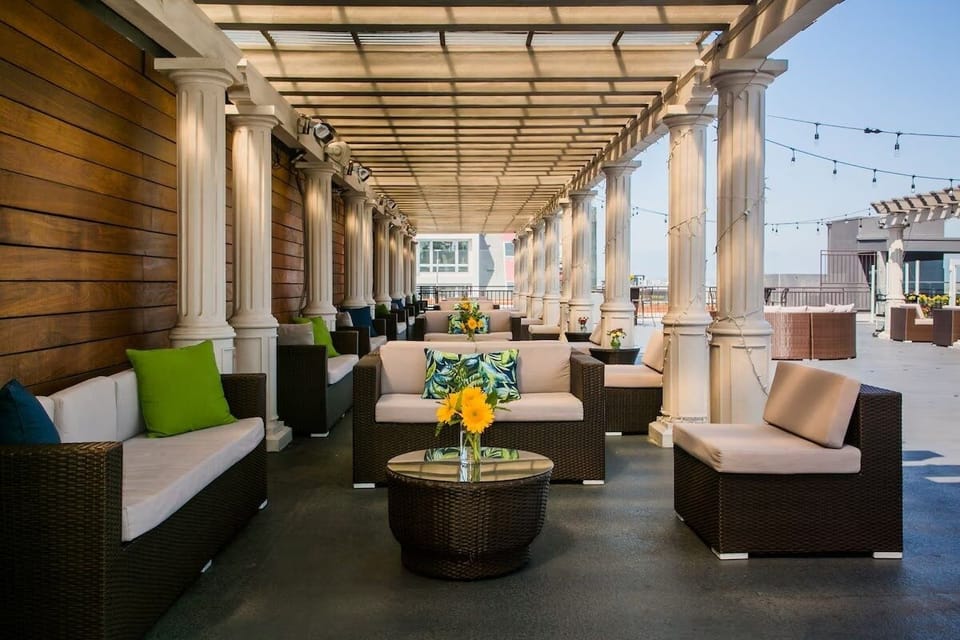 Unwind under the pergola with plush seating and breezy shade.