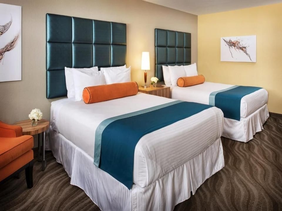 Unwind together with two plush beds and cozy bedside lighting.