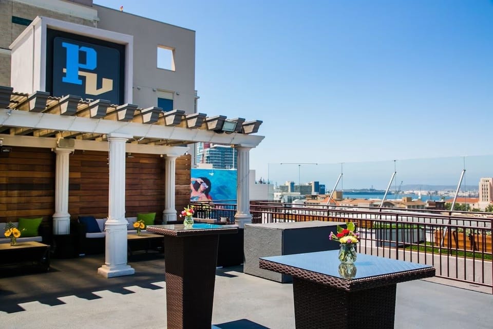 Toast at high-top tables overlooking the bright waterfront horizon.