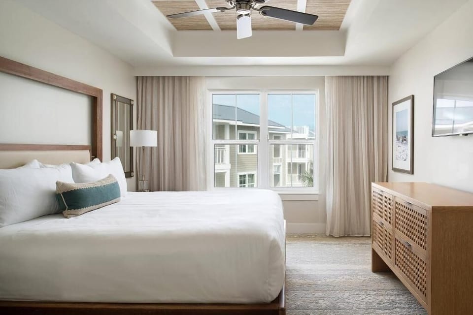 Drift off in a serene king room with balcony glow.