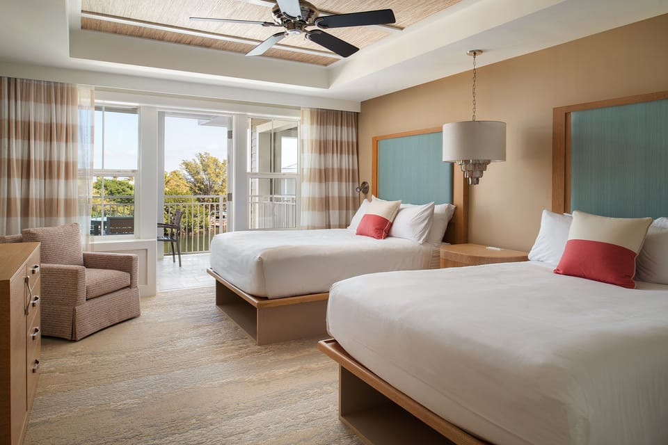 Wake up refreshed with balcony breezes and plush double beds.