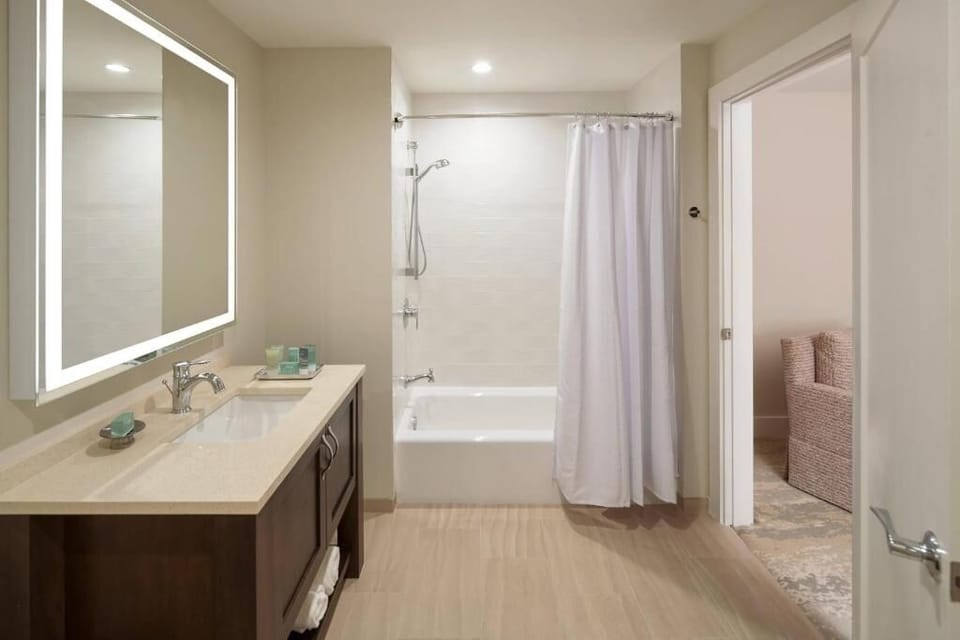 Refresh under a soothing shower beside a deep soaking tub.