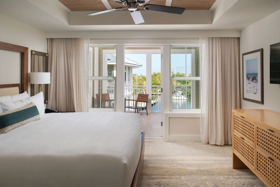 Sink into crisp linens and wake to balcony views.