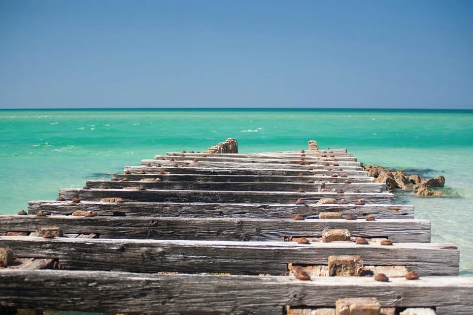 Stroll out to endless turquoise horizons from weathered docks.