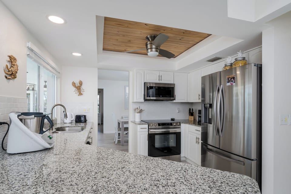 Kitchen With Rustic Accent Ceiling