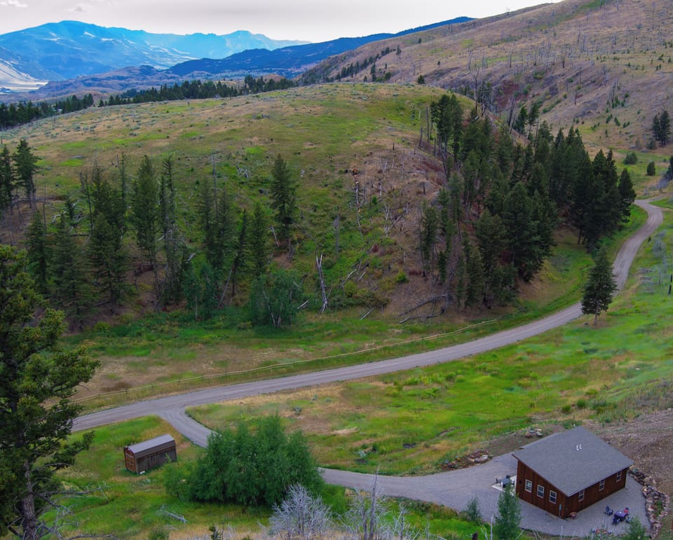 A bird's-eye view of the 3-acre property from above. The quiet backroad is a delight to walk or bike along - with stunning views of the valley below. From the cabin, you won't see any neighbors. 