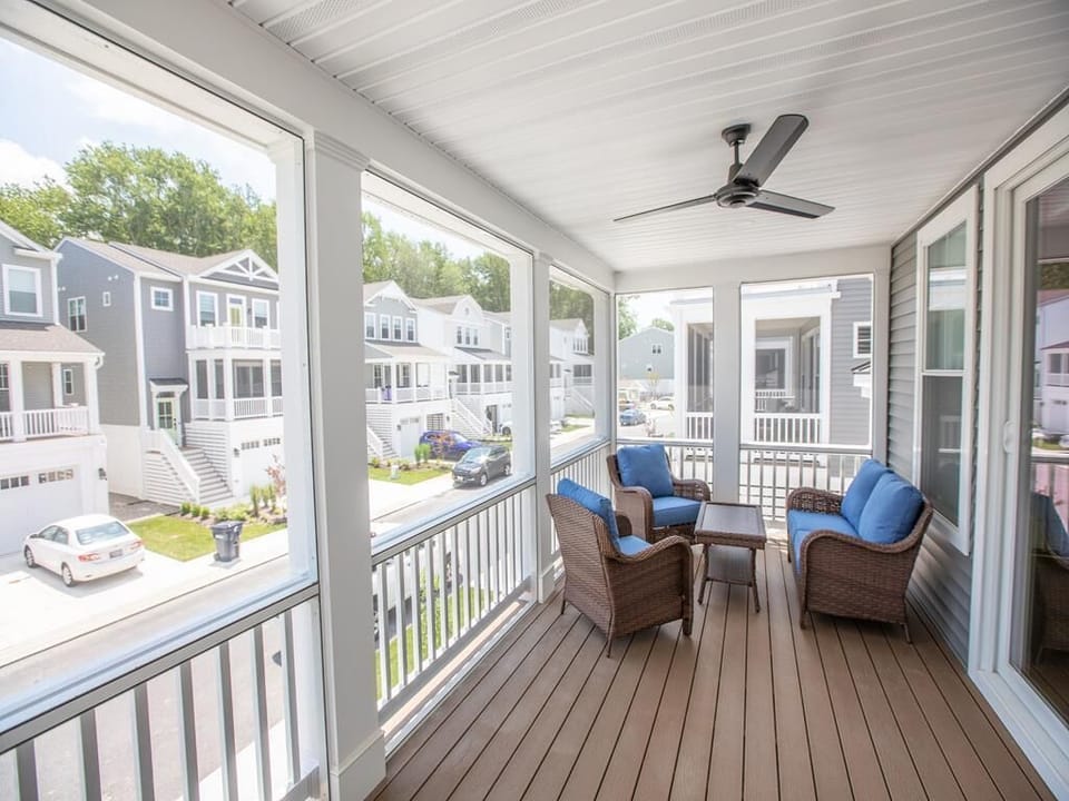 Top-level screened porch offers another breezy, peaceful outdoor space to enjoy.
