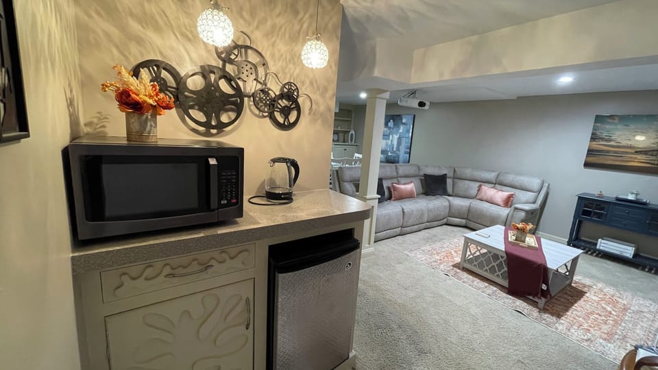 Mini fridge, microwave, water cattle and wine glasses