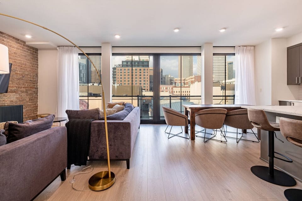 Spacious Open Floor Concept Living Room with Balcony Access