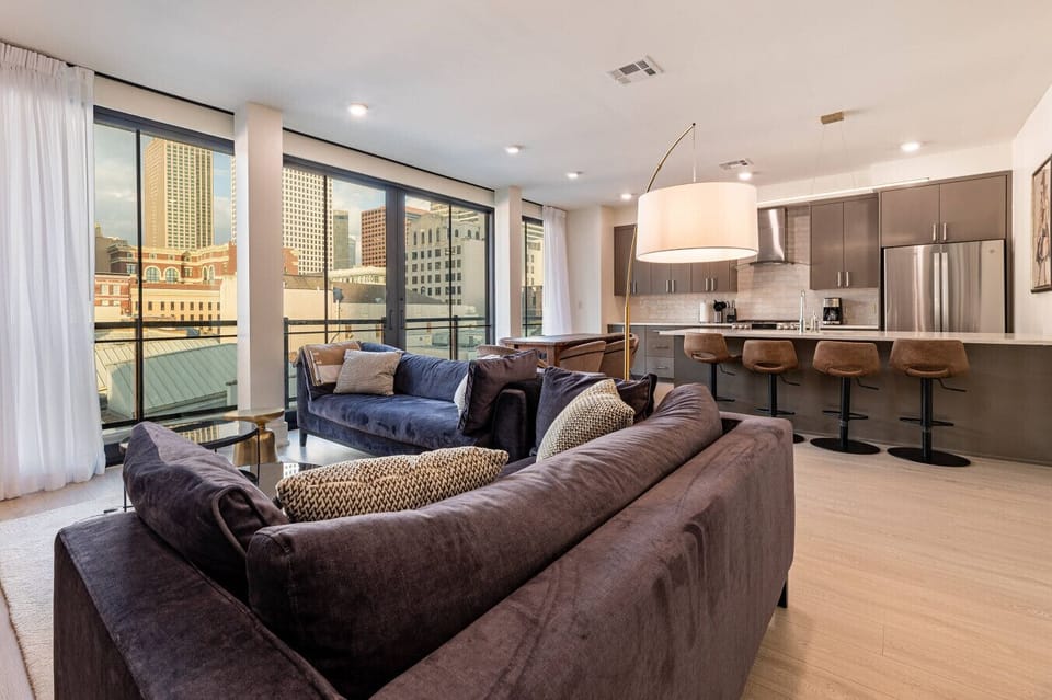 Spacious Open Floor Concept Living Room with Balcony Access