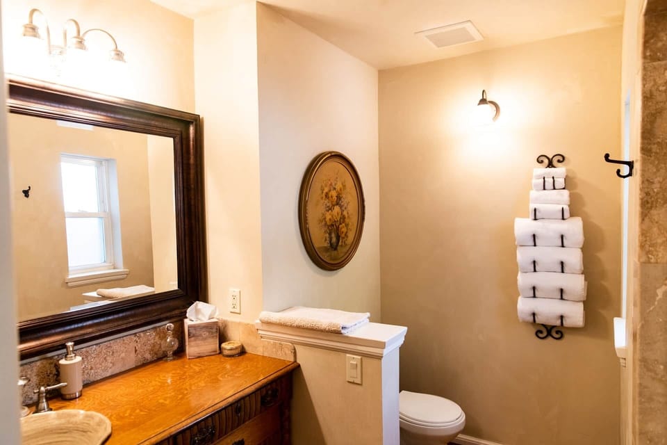 Bright bathroom with plush towels and antique-chic details