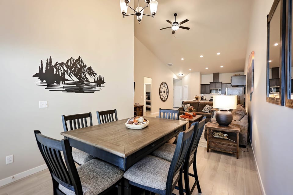 Large dining table with mountain mural; perfect for family meals and game nights.