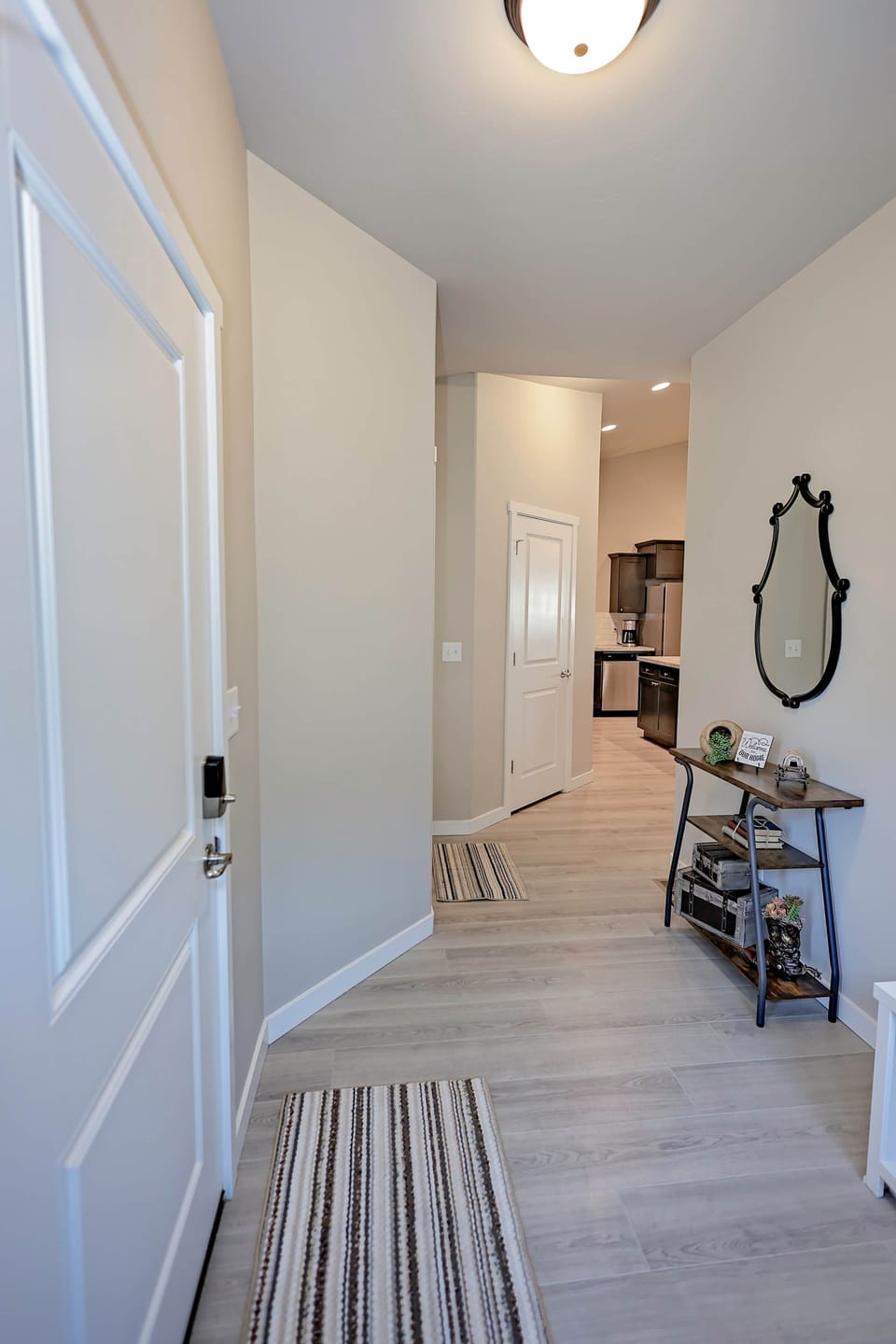 Welcoming front hall with mirror and console table leading to the main living space.