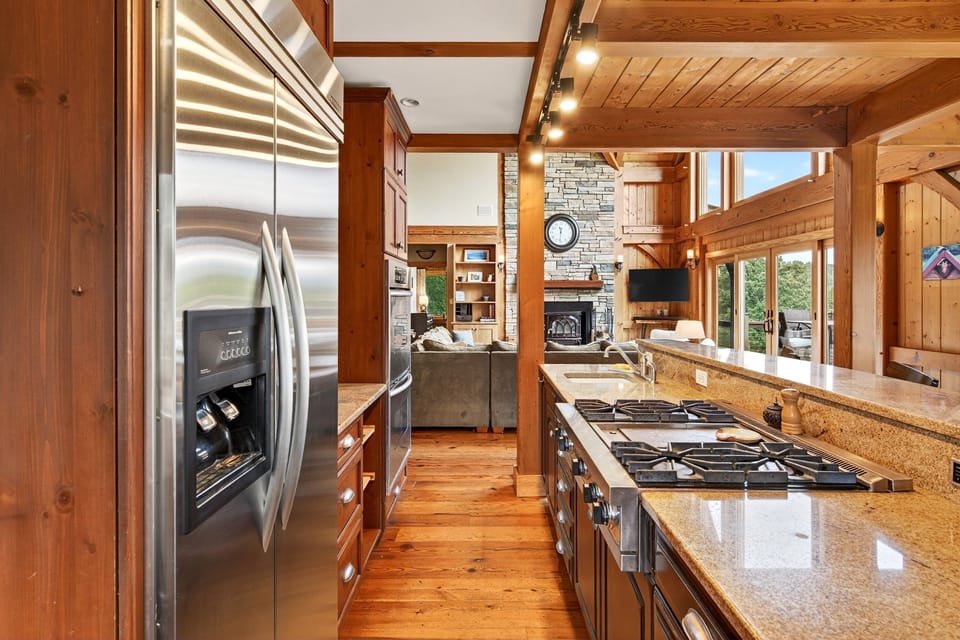 Well-equipped kitchen with gas range, drip-style coffee maker, dining area for 8, and island seating for 3