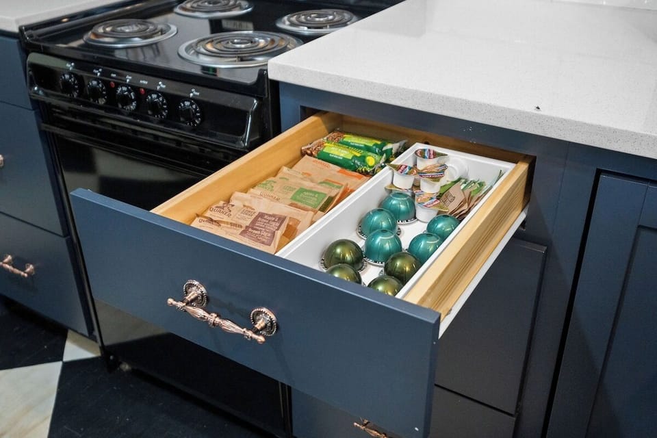Coffee pods, sugar, creamer, and light breakfast items are provided.