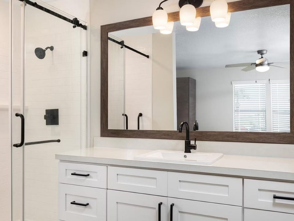 Get ready comfortably at the spacious vanity with warm lighting.