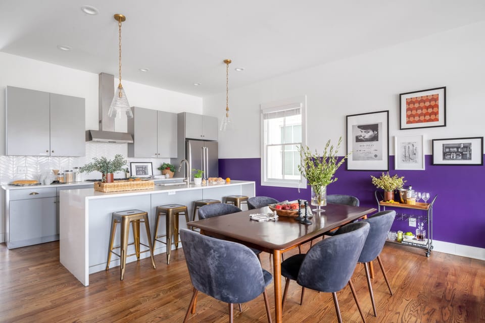 Kitchen features an island with countertop seating and a table for 6. (Reba)