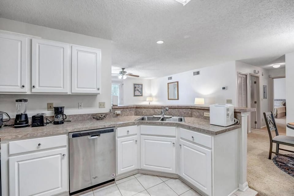 Spacious kitchen layout w/ generous counters and bright cabinetry
