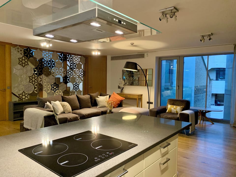 Kitchen island with view to sofa and armchairs
