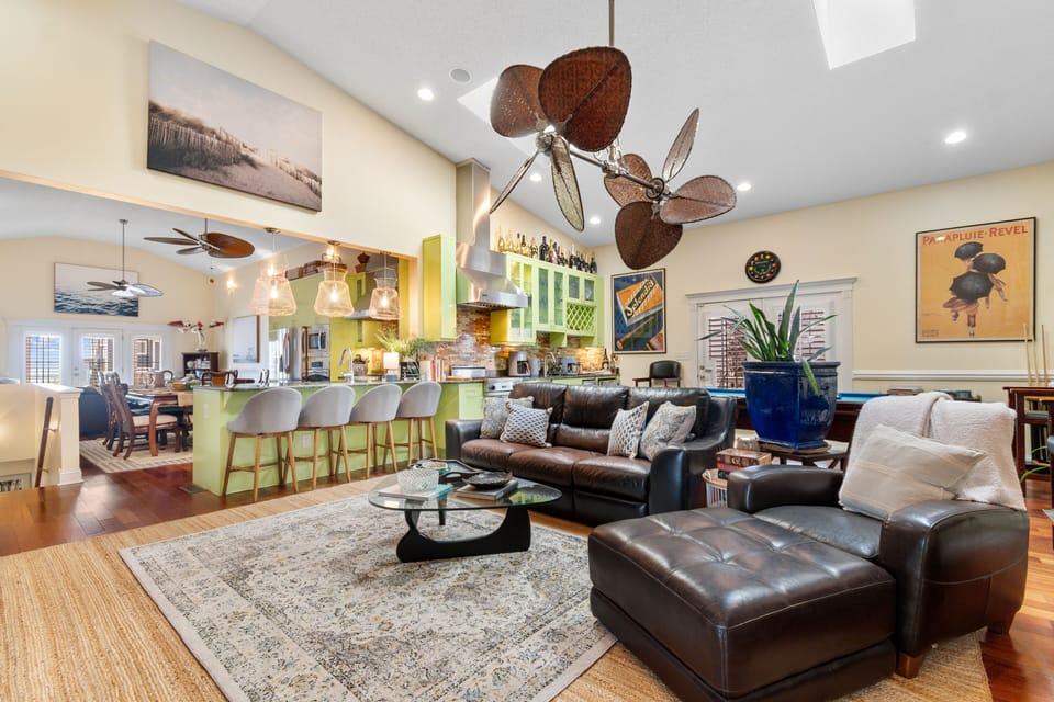 Your stylish retreat features warm leather seating, tropical ceiling fans, and a vibrant open kitchen perfect for gathering with loved ones.