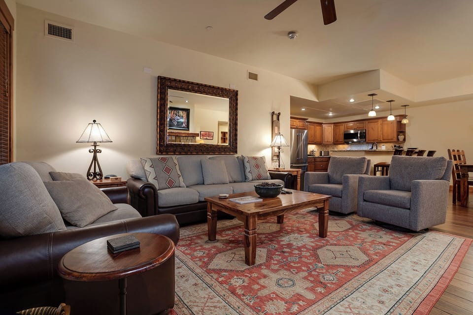 Unwind in your spacious living room with plush seating and warm wood accents flowing into the gourmet kitchen.