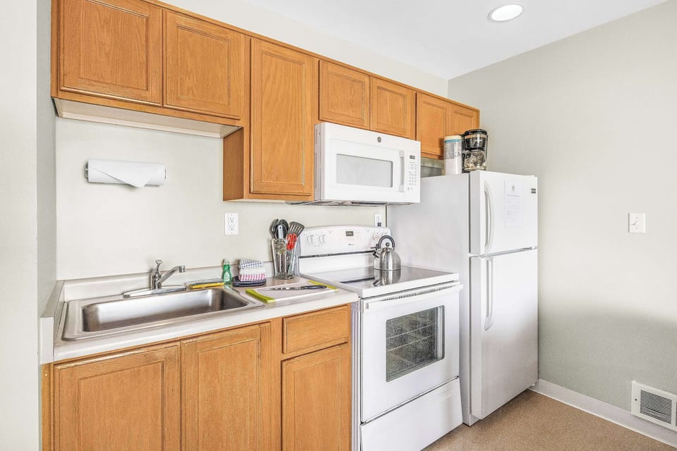 The kitchen is fully equipped with appliances