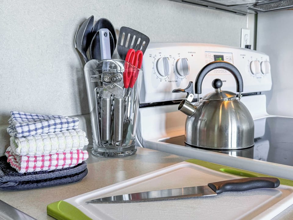 The kitchen is fully stocked with utensils and cookware