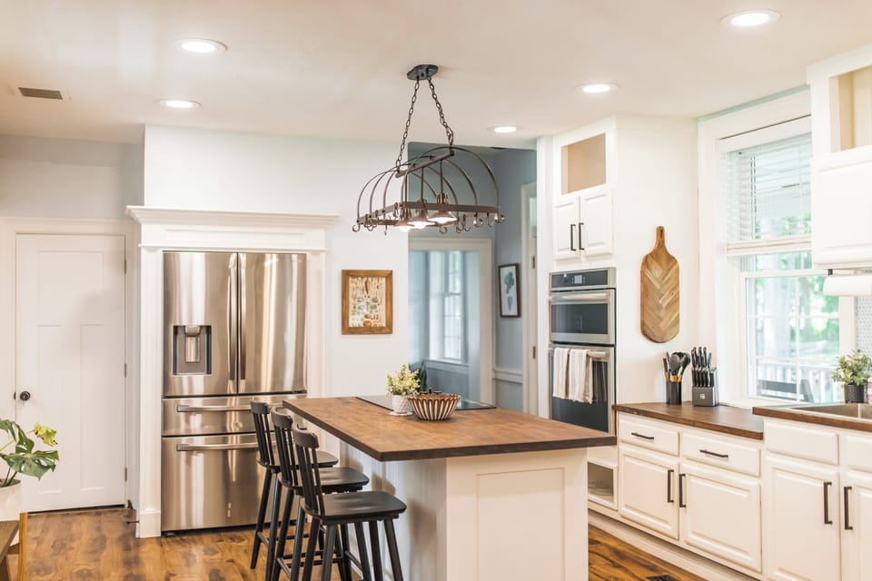 Open kitchen connected to dining room, with bar seating for three 