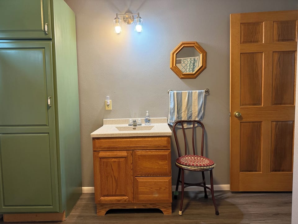 Main floor bathroom sink and linen/towel closet.