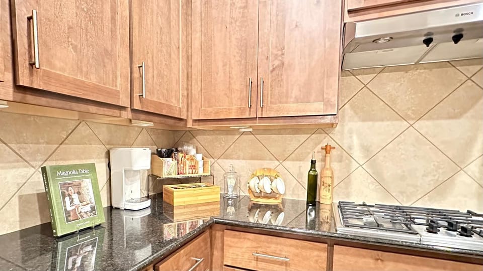 Coffee bar setup, gas cooktop, and granite counters for your culinary needs.