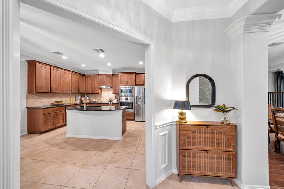 Spacious gourmet kitchen view from the entryway with stylish console table.