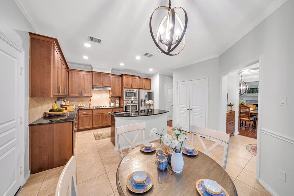 Fully equipped kitchen with granite counters, island, and breakfast nook. 
