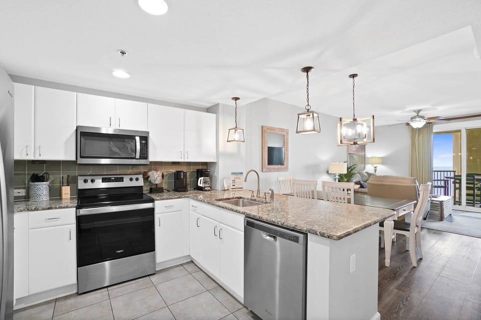 Your fully equipped kitchen features granite countertops, stainless appliances, and a breakfast bar where you can sip coffee while enjoying ocean views.