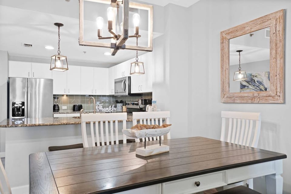 Gather around your beautiful farmhouse dining table where warm pendant lighting creates the perfect ambiance for memorable meals and conversations.
