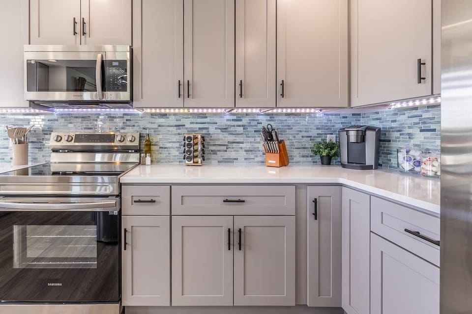 Bright counters, gleaming appliances, and the inviting scent of fresh coffee—this kitchen corner makes every cooking moment feel effortless and welcoming.
