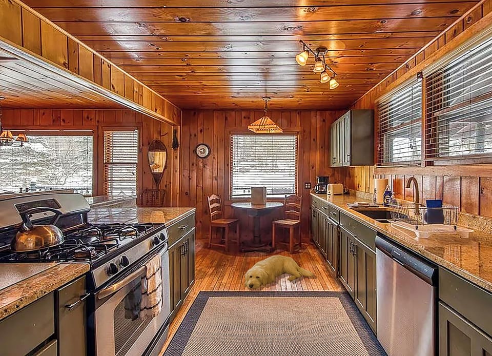 The kitchen is fully stocked with cookware, utensils, and spices.