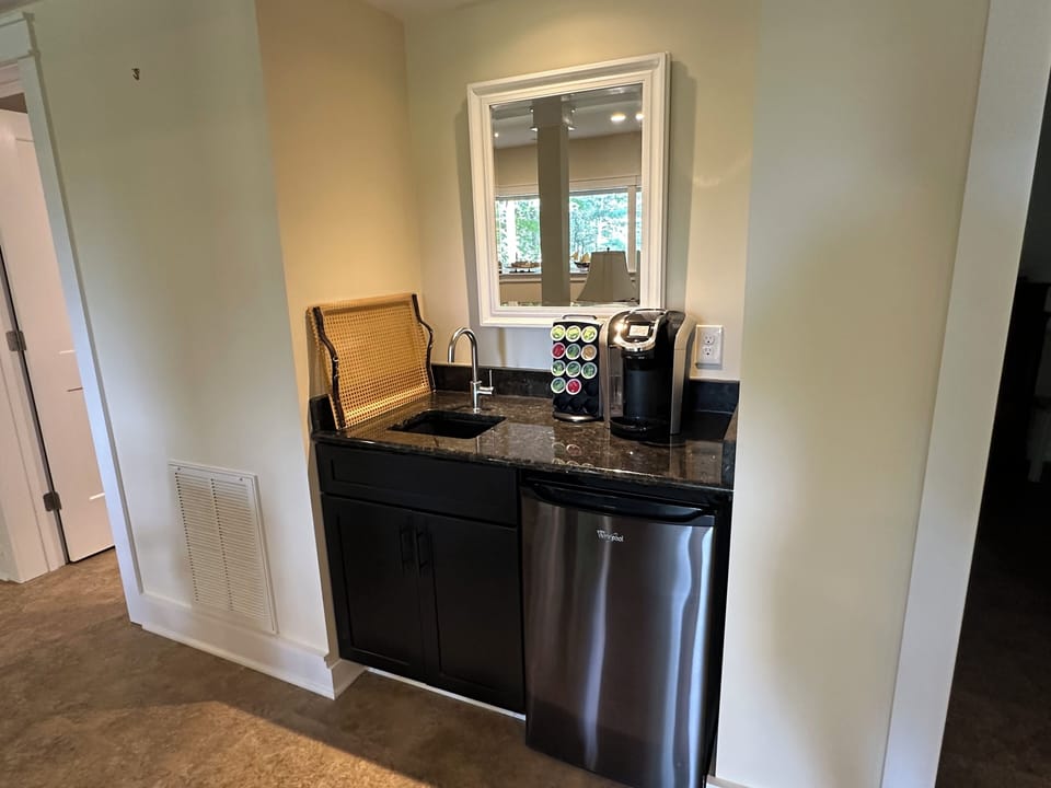Basement bar with sink and fridge