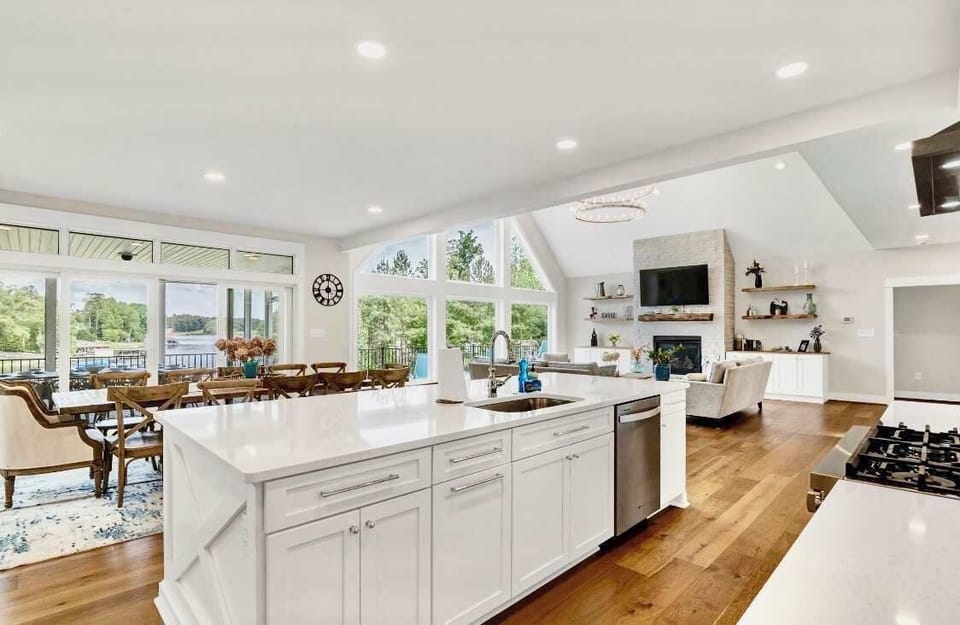 Those lake views from every room! It never gets old!  Whether dining at the kitchen island, or on the Restoration Hardware dining table or on the screen porch, party deck or the great room wall of windows - it's big water views - all day long!!