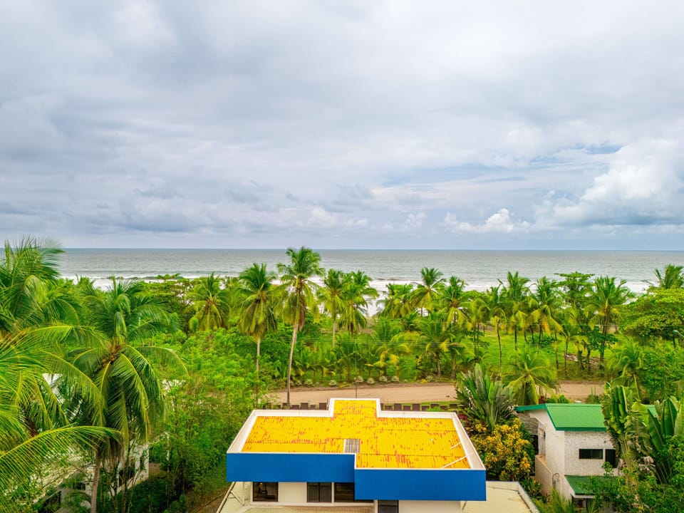 Across the street from the ocean. Home is with the yellow roof.