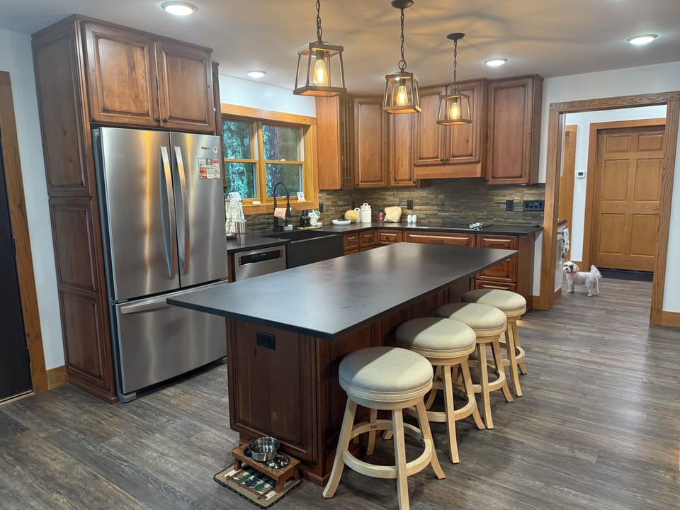 Cook & Gather in Modern Kitchen w Granite & Stainless Appliances