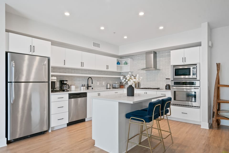 Fully equipped chef's kitchen with sleek, high-end stainless steel appliances.